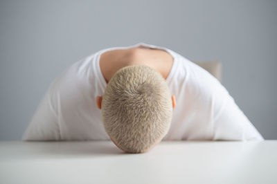 Close-up of woman relaxing on white background