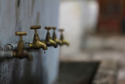 Faucets arranged in row on wall