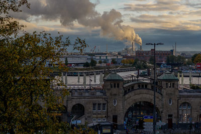 Buildings in city against cloudy sky