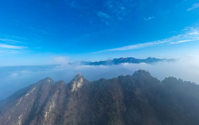 Panoramic view of mountains against blue sky