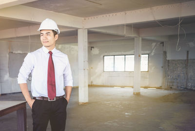 Portrait of man standing in corridor