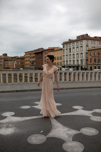 Beautiful woman standing on road in city
