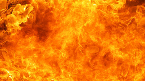 Close-up of fire burning against black background