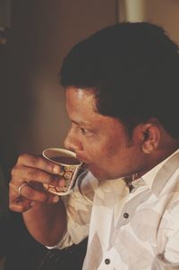 Side view of young man smoking cigarette