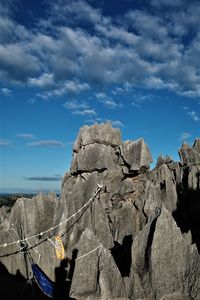 Low angle view of rock formation against sky
