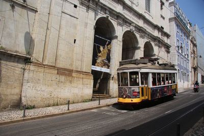 Cars on street by buildings in city