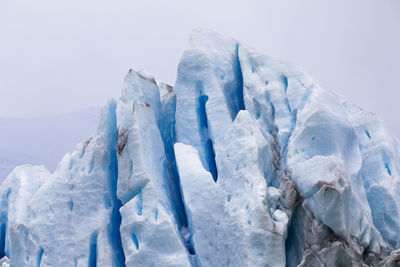 Panoramic view of snow covered landscape against sky