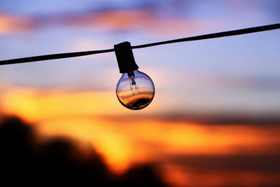 Low angle view of light bulb against sky