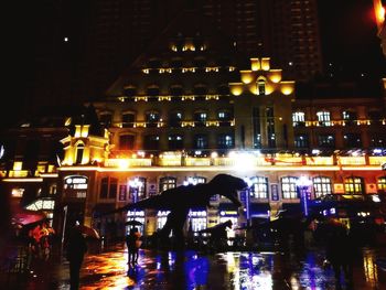 Reflection of illuminated buildings in city at night