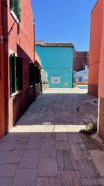 Footpath amidst buildings in city