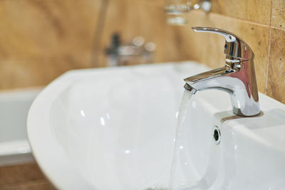 Close-up of faucet in bathroom