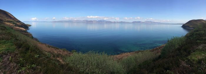 Scenic view of sea and mountains against sky