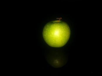 Close-up of apple against black background