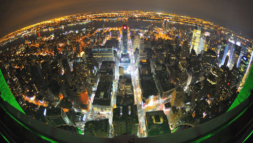 Close-up of illuminated cityscape against sky at night