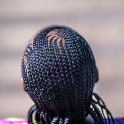 The back view of a lady with african braids