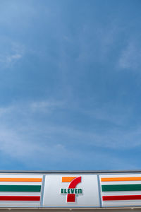 Low angle view of flags against blue sky