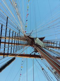 Low angle view of sailboat sailing against clear blue sky