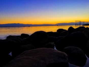 Scenic view of sea against clear sky during sunset