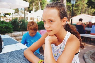 Close-up of girl looking away at outdoor restaurant