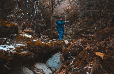 Man standing in forest during autumn