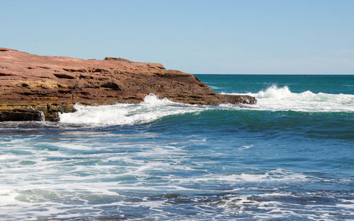 Scenic view of sea against clear blue sky