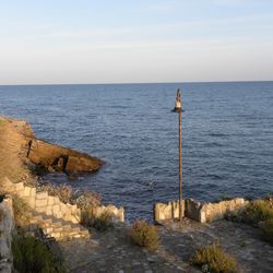 Scenic view of rock formation in sea against sky