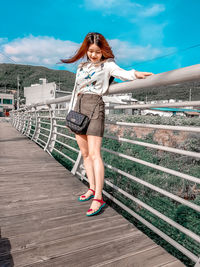 Full length of woman standing against the sky