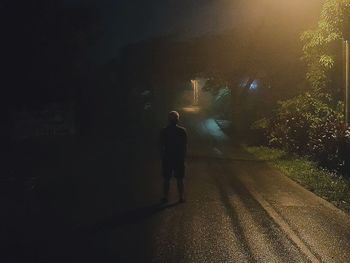 Full length of woman walking on illuminated street light