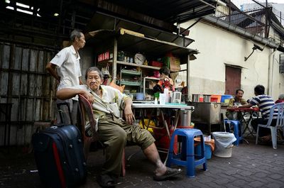 Full length of woman sitting on bench