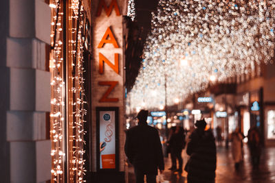 People in illuminated building at night