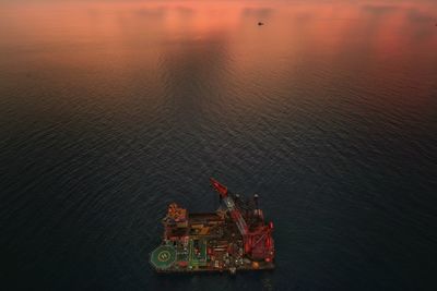 High angle view of ship in sea against sky during sunset