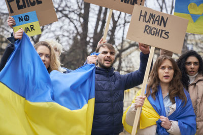 Portrait of smiling young woman holding flags