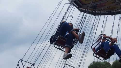 Low angle view of swing ride at amusement park