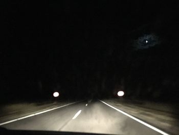 Road passing through tunnel at night