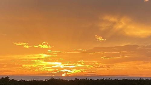 Scenic view of dramatic sky over sea during sunset