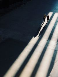 High angle view of couple walking on street