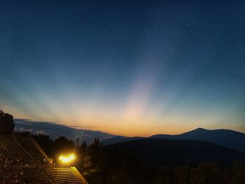 Scenic view of silhouette mountains against sky at sunset