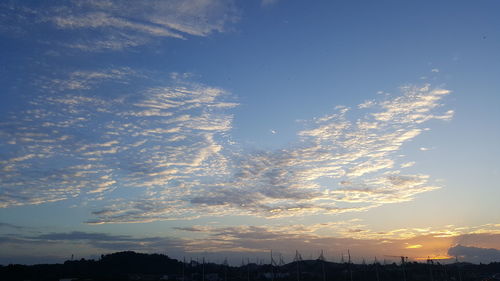 Silhouette cityscape against sky during sunset