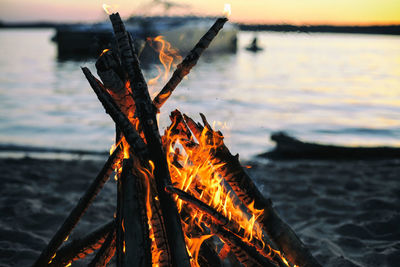 Close-up of campfire at beach