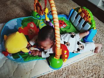 High angle view of baby playing with toy