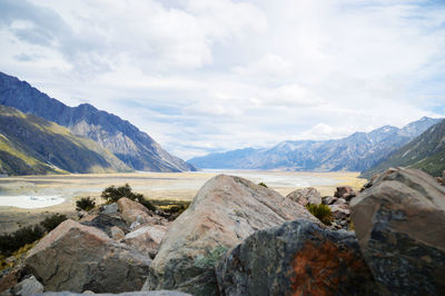 Scenic view of mountains against cloudy sky