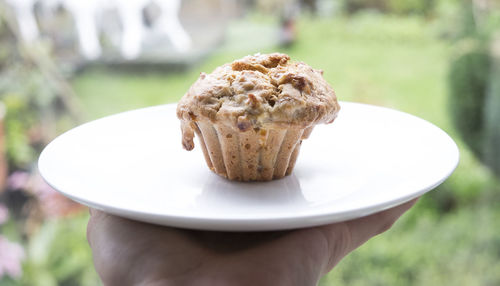 Close-up of hand holding ice cream cone
