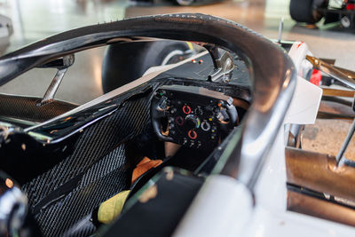 Detail view of the steering wheel with integrated controls of a single seat competition car.