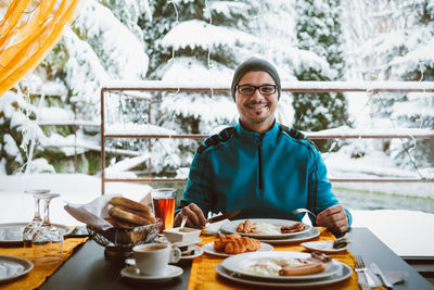 Portrait of young man having food