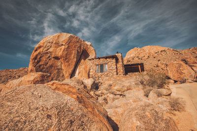 Rock formations on landscape against sky