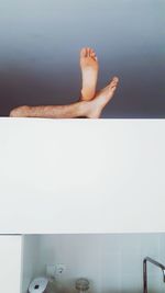 Low section of woman relaxing in water