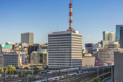 Modern buildings in city against clear sky