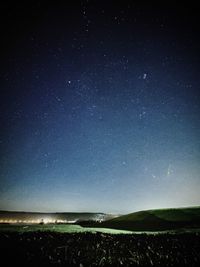 Scenic view of landscape against sky at night