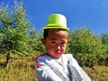 Boy in park against sky