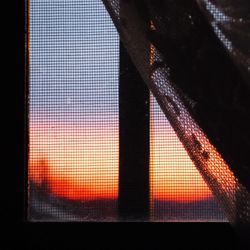 Close-up of window at sunset